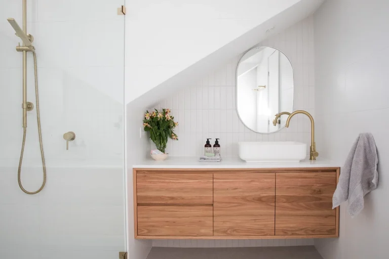 white bathroom with wooden cabinets