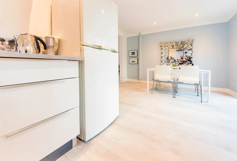 view from the kitchen of the grey renovated dining room after the renovation of the house