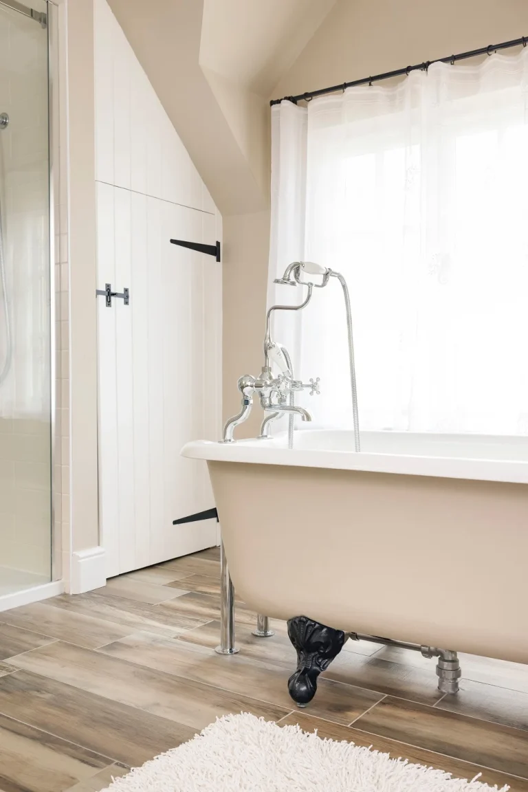 white freestanding bathtub in renovated bathroom