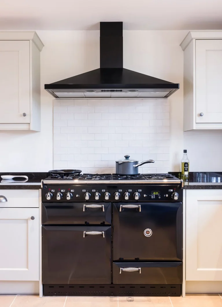 white kitchen with black appliances